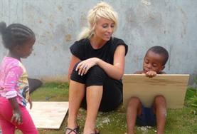 Culture & Community Volunteer in Jamaica Does Art Project with Children Volunteer on the Maroon Culture & Community project in Jamaica paints with local child