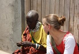 Volunteer with the Maasai Community in Tanzania with Projects Abroad Volunteer on the Culture & Community project in Tanzania chatting with a Maasai community member