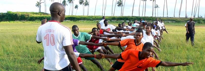 Volunteer Coaches Rugby Team at a School School rugby practice with volunteer coach in Ghana
