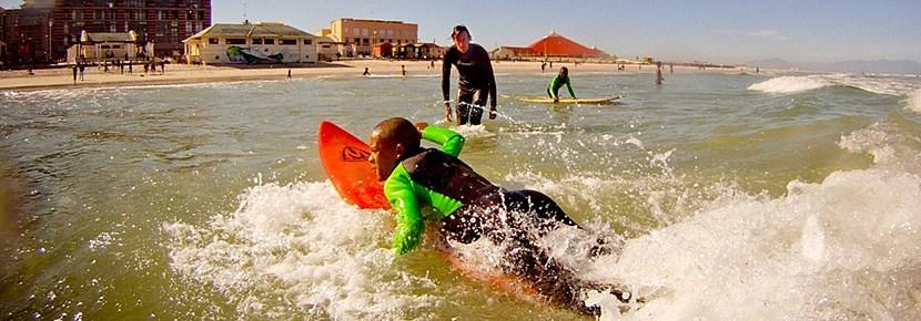 Volunteer Surfing Projects in the Developing World with Projects Abroad Volunteers teach surfing lessons to kids in the developing world with Projects Abroad